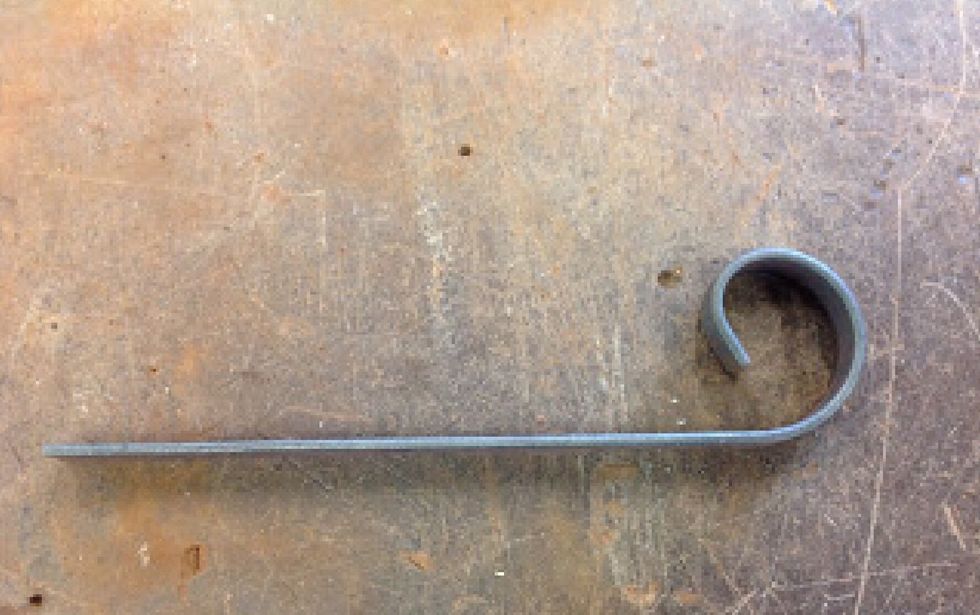 Now your scroll should look like this. Using your metal ruler and scribe measure 80mm in and use the hack saw to cut off the feet. Then file the ends