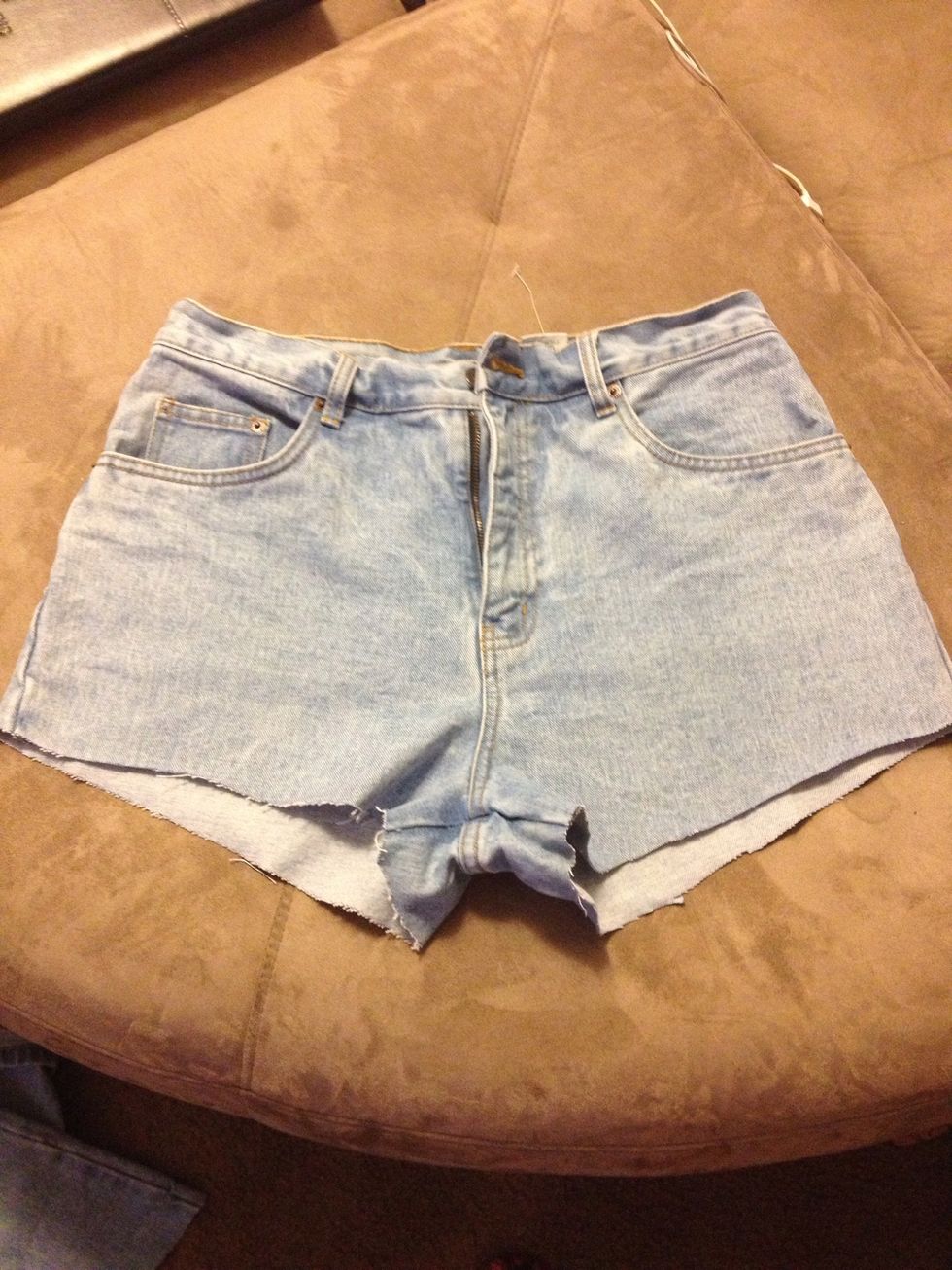 Now your shorts need some distressing. Use your marker to mark lines then use scissors to cut the lines. Cut slits in the rims on your pockets and use the sand paper to rough up the edges.