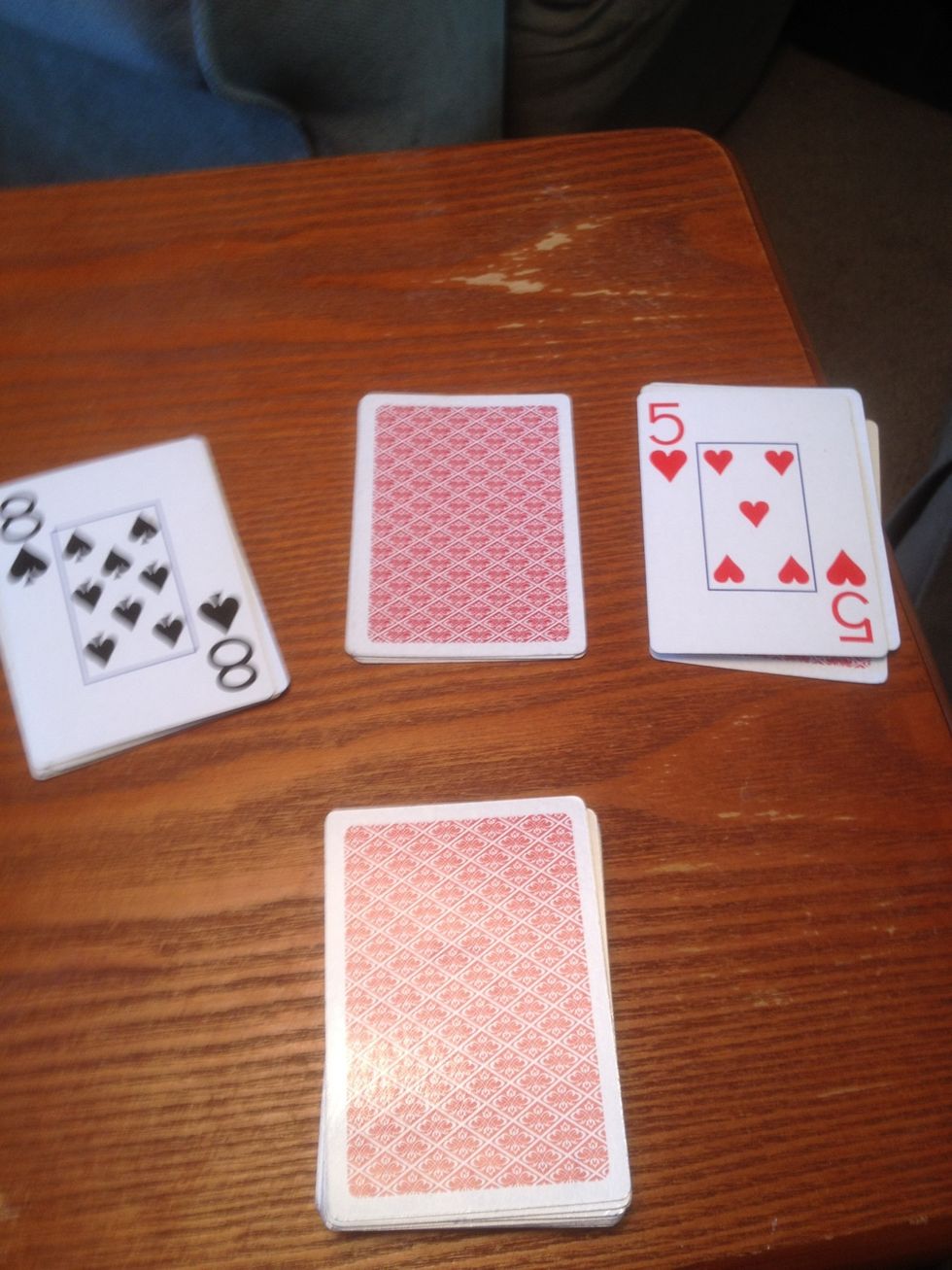 Of the three stacks that were kept, flip over two cards and add the total of them together and add 10. In this example we have a five and an eight for 13 plus 10 to equal 23. Remember this number.