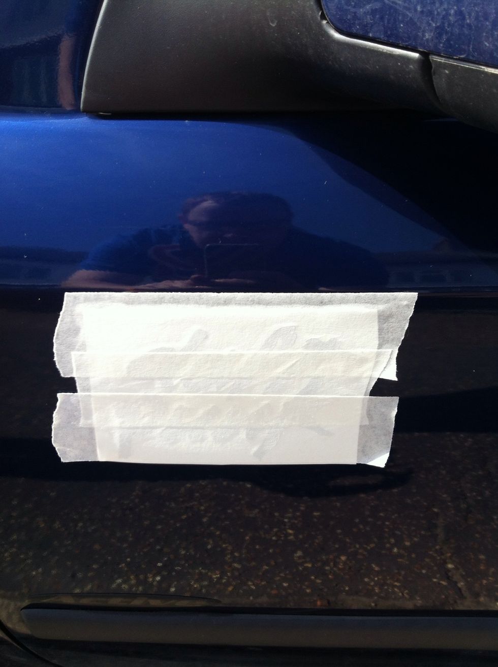 Offer the sticker/decal to the surface you wish to stick it to and position in place with some masking tape (with this decal I used the excess application tape to position the decal in place)