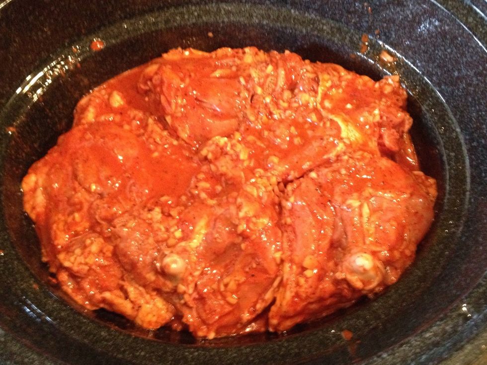 Oil the bottom and side of your slow cooker and lay in the chicken thighs, skin side down. Pour in any remaining marinade from the bag. Cover it and cook on high until the meat is tender (2.5 hrs?)