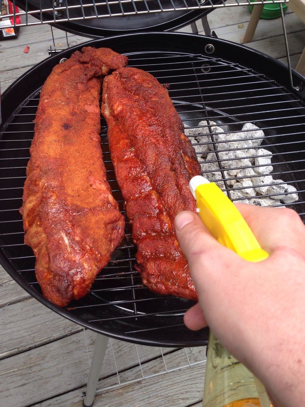 Ok, so it's been 90 minutes since you opened the grill, right? Ok, good. Now spray the ribs down with some apple juice for flavor and to help keep the meat moist.
