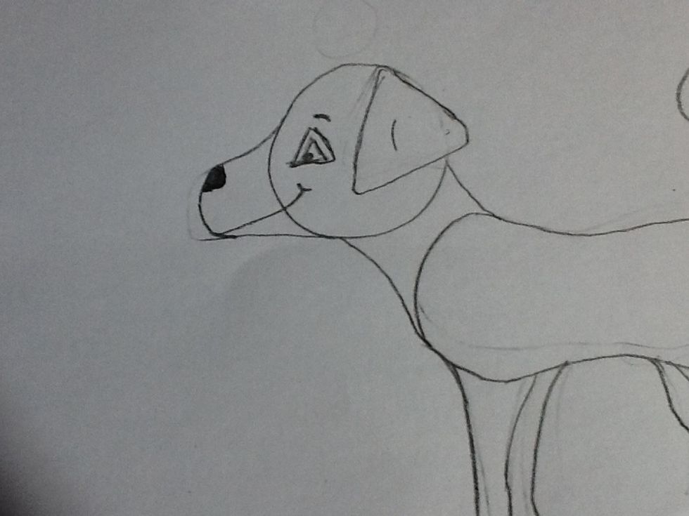 Ok so we have drawn the structure but we need features! I draw his eyes with 2 triangles and a dot in the corner. His ear is also a triangle! I draw a big curvy line for a smile, up to his eye!
