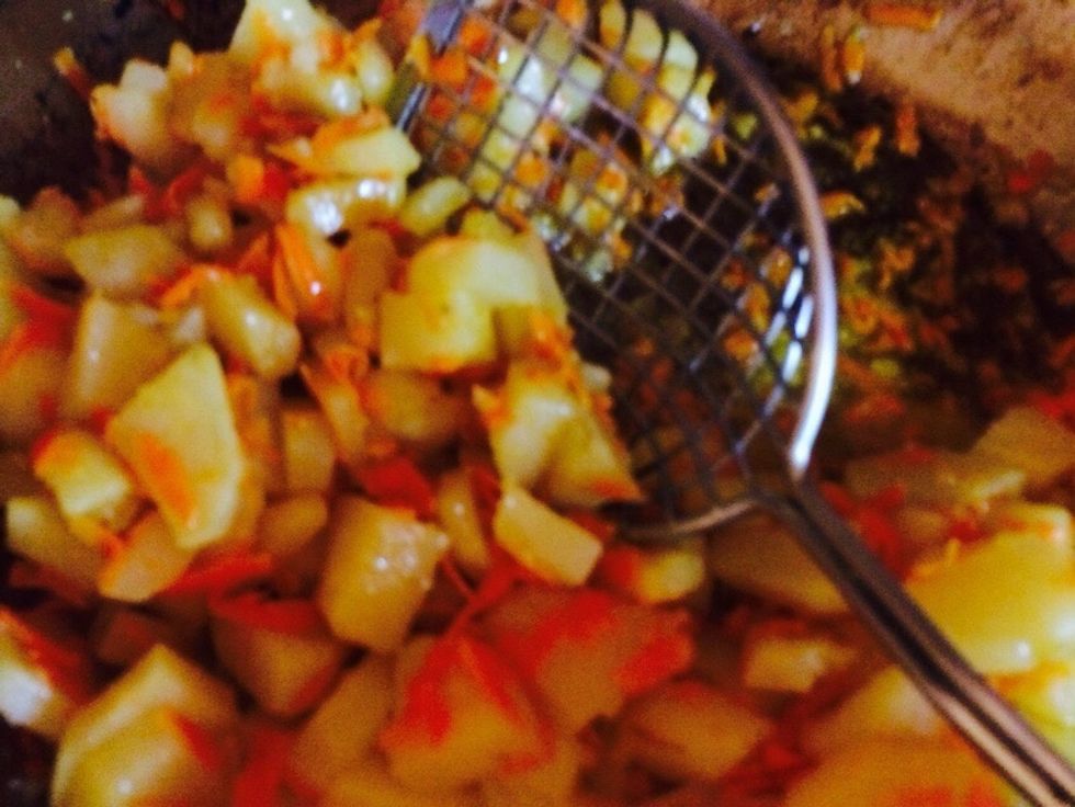 Ok the potatoes are soft. Scoop up with a draining spoon and add to big pot.