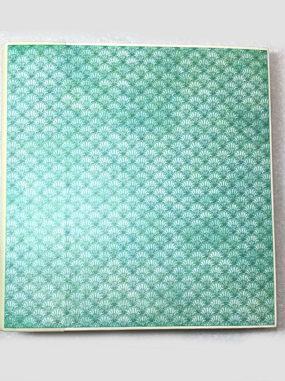 Ok time to put this all together. Trim the 12x12 paper shown to 8"w x 8.5"h. Adhere to the album front using matte medium. Be sure to apply matte medium to both the album and the back of the paper.