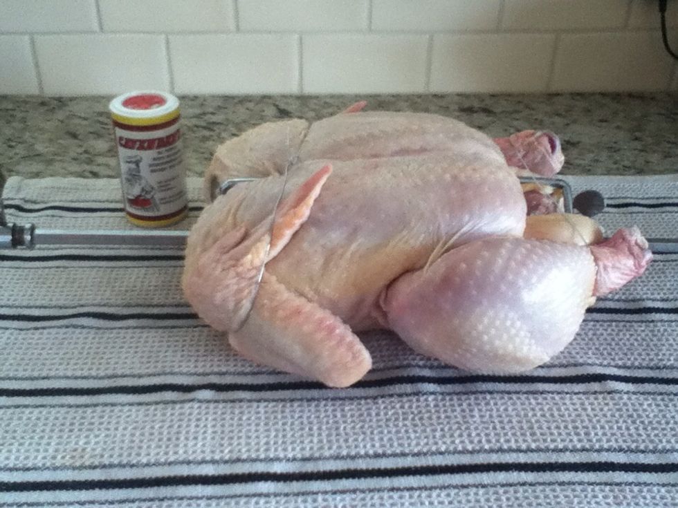 Okay, get your chicken ready by simply tying some wire around the wings and legs so they don't flop around while being on the rotisserie.