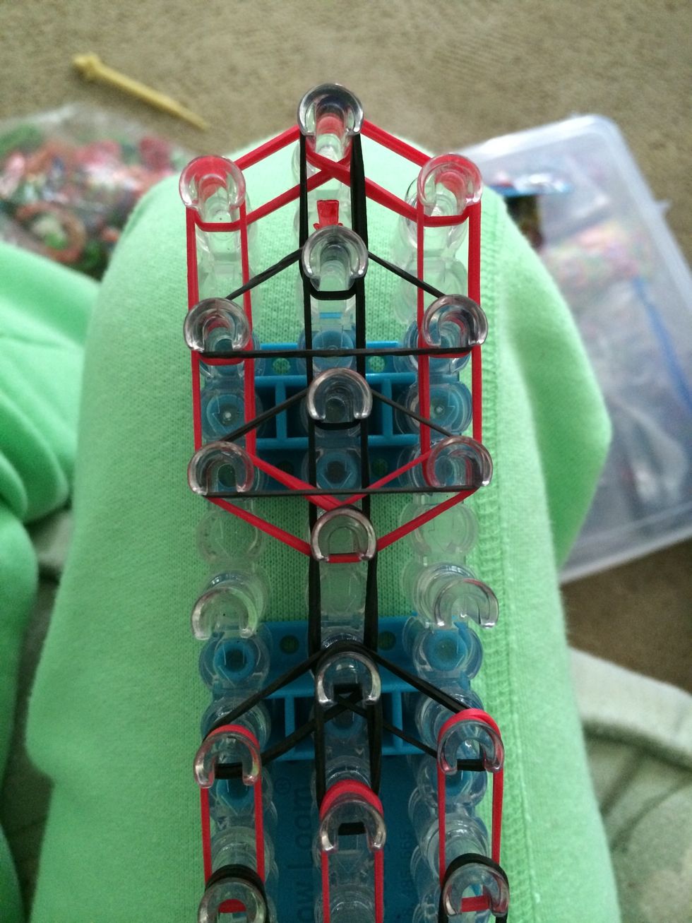 Okay now let's add the last remaining capping bands. Grab 2 black bands and double loop 2 triangles. This is going to give the top of our tie a tighter shape.