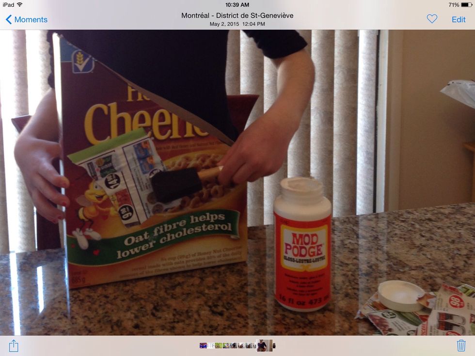 Okay now you take your old magazine and rip as much pages of the magazine as needed now you need your sponge brush and mod podge  grab a piece of magazine and put mod podge on it repeat this step