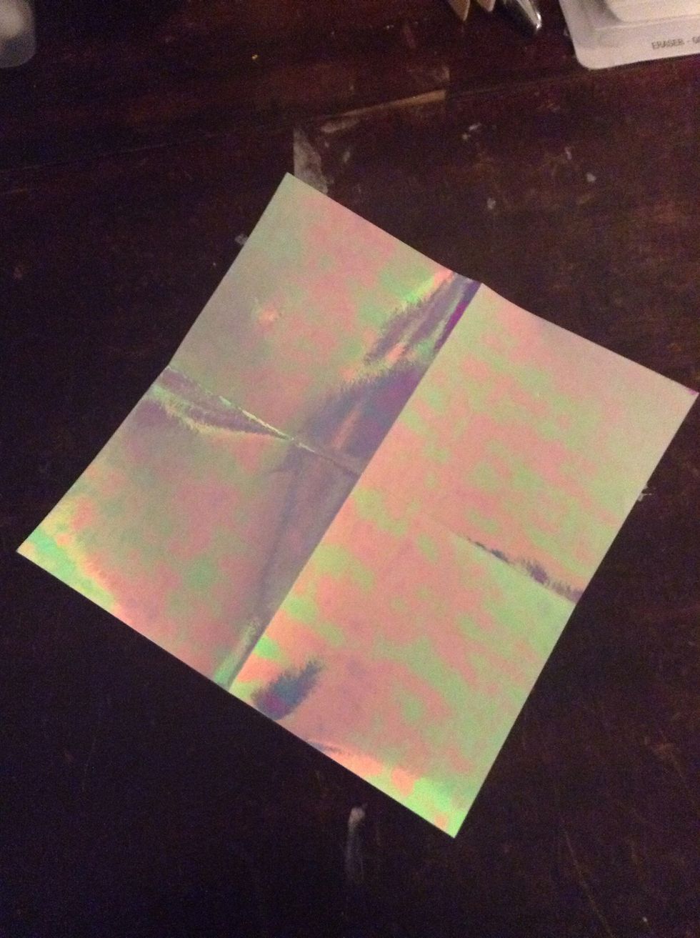 Okay so I have origami paper. Fold it into fourths.  (If you don't have origami paper, you can make a square from regular paper.)