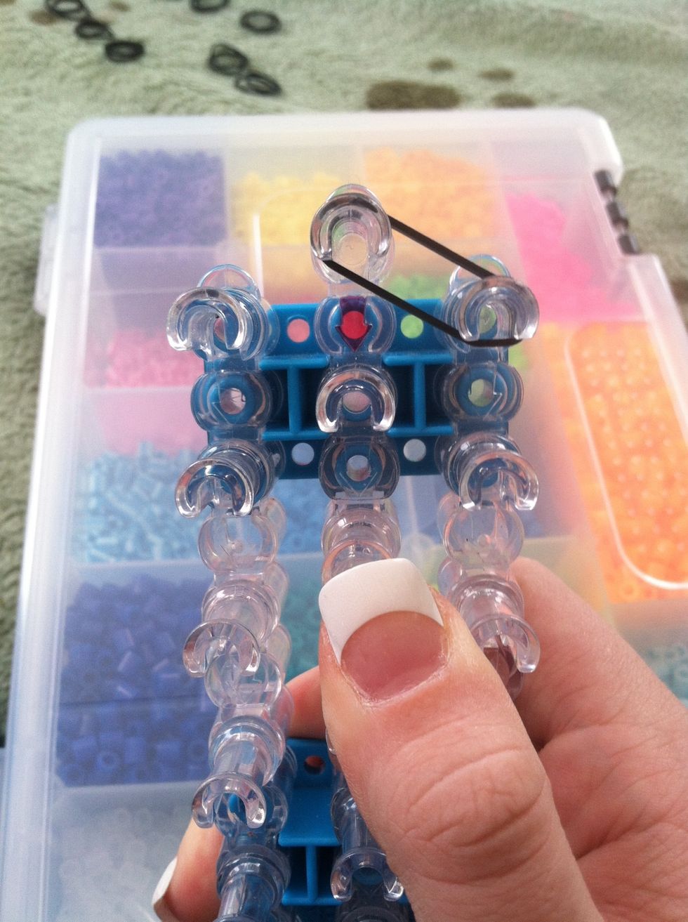 Okay. Starting from the top peg place a diagonal double band to the right