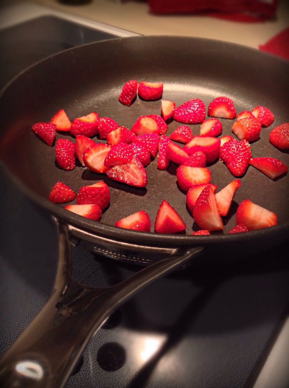 Okay this is a pretty easy recipe but its so yummy so I had to share! Now, get your sliced strawberries into a pan on medium to high heat.