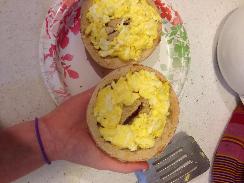Okay, this next part is very hard and requires skill (to a degree). Hold the bagel top in one hand and quickly flip it over onto the other bagel so none of the eggs fall out.