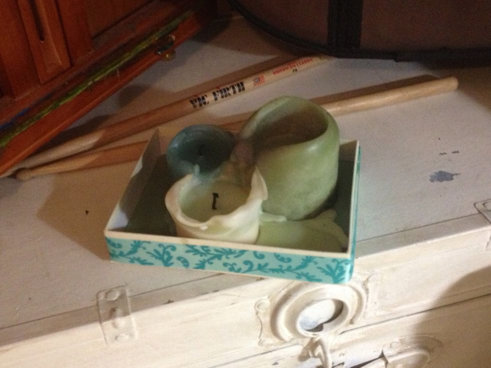 Old candy box (or jewelry /gift box) with a little sand and some stand alone candles. Wrap some ribbon for an added touch. Saves your surface, $$ and the planet. Those are soy based candles right?