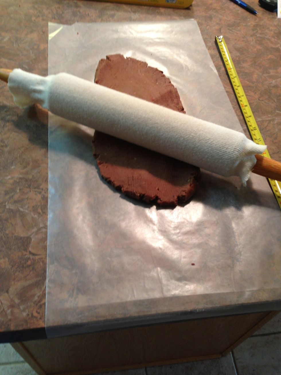 On 24" sheet of wax paper, roll chocolate dough to 10" x 17" rectangle. I used to try to hold it still by folding edge over counter but check out a better way in next slide...