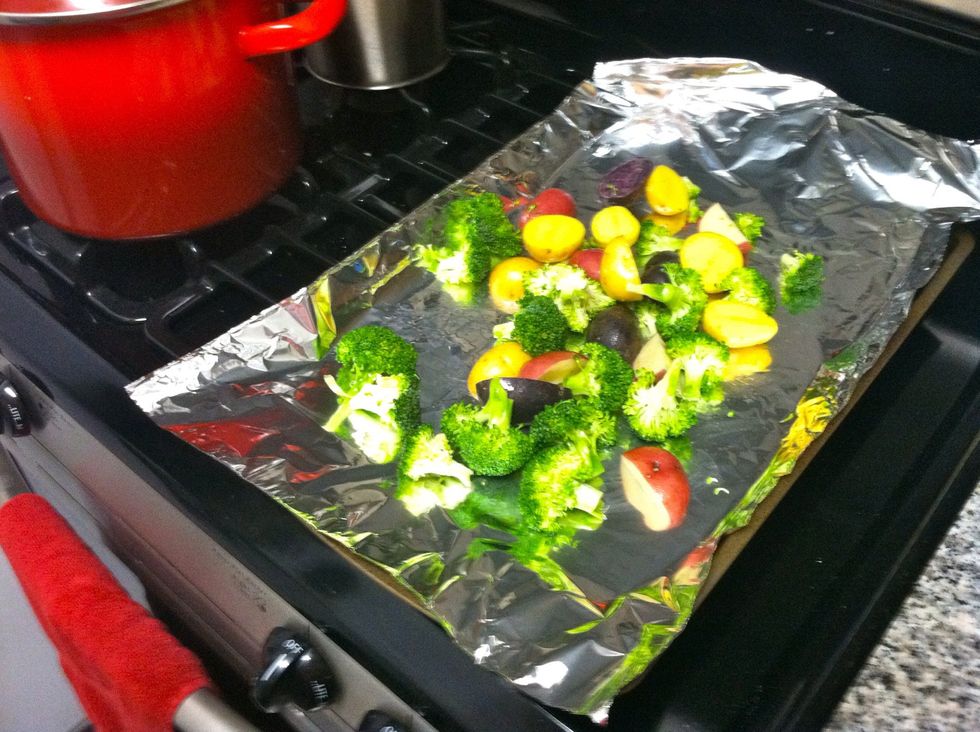 On a baking sheet, toss the potatoes and broccoli with 2 tablespoons of the oil, 1/2 teaspoon salt, and 1/4 teaspoon black pepper. Roast, tossing once, until the vegetables are tender, 25-30 minutes.