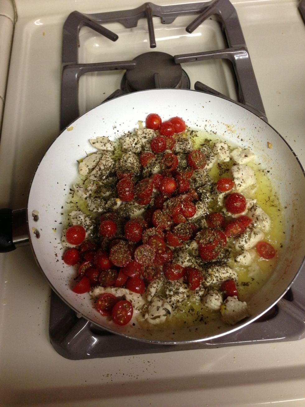 On a chickens cooked add tomatoes, basil, chili flakes (sparingly), salt and pepper. I crush down the tomatoes to make them softer in the dish.