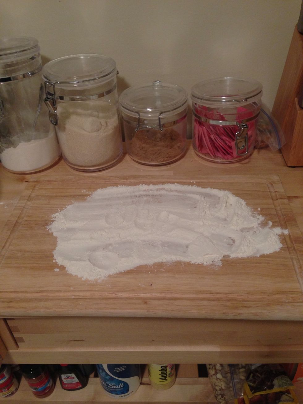 On a cutting board, add about 1/4 cup of flour and spread it out. You will add the dough to this when it is complete.