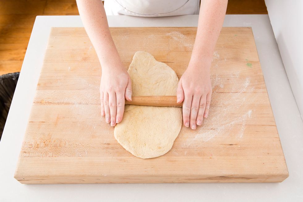 On a floured board, roll out your pizza dough to about 12 inches.