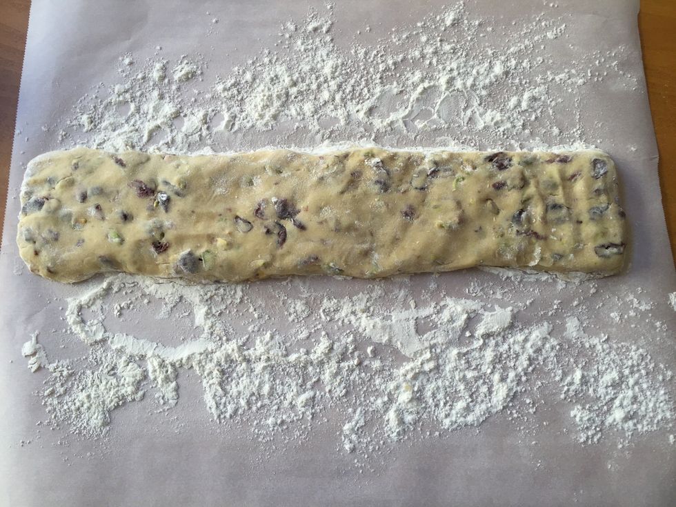On a floured surface, shape biscotti dough into 2 14-by-2 inch logs. Flatten slightly and place on parchment paper-lined baking sheet.