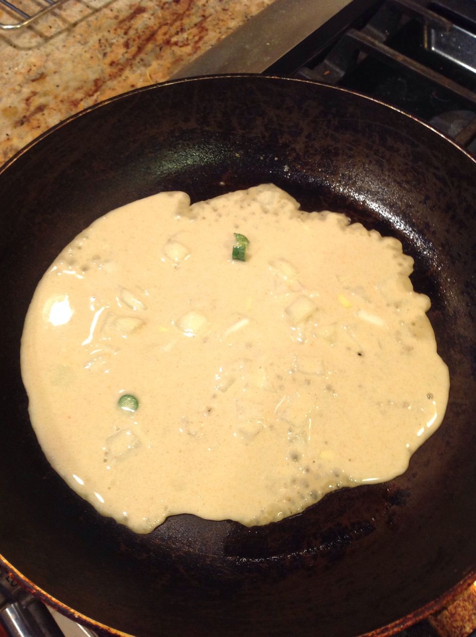 On a heated & lightly greased pan (on medium flame), pour in half a cup of batter.