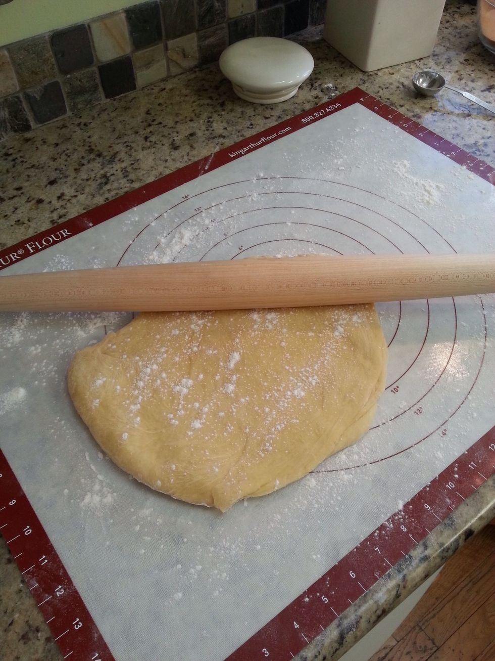 On a lightly floured work surface, use a rolling pin to roll the dough out.