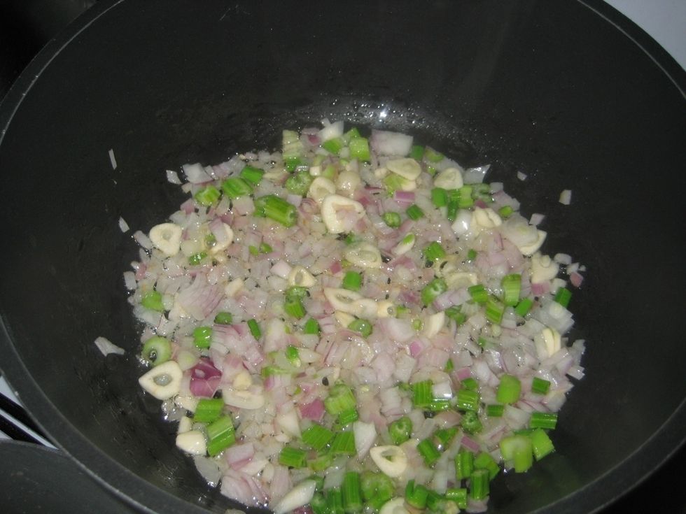 On a low heat and with 2 tablespoons oil, cook the onion, garlic and celery for about 2 minutes or till softened stirring to allow even cooking.