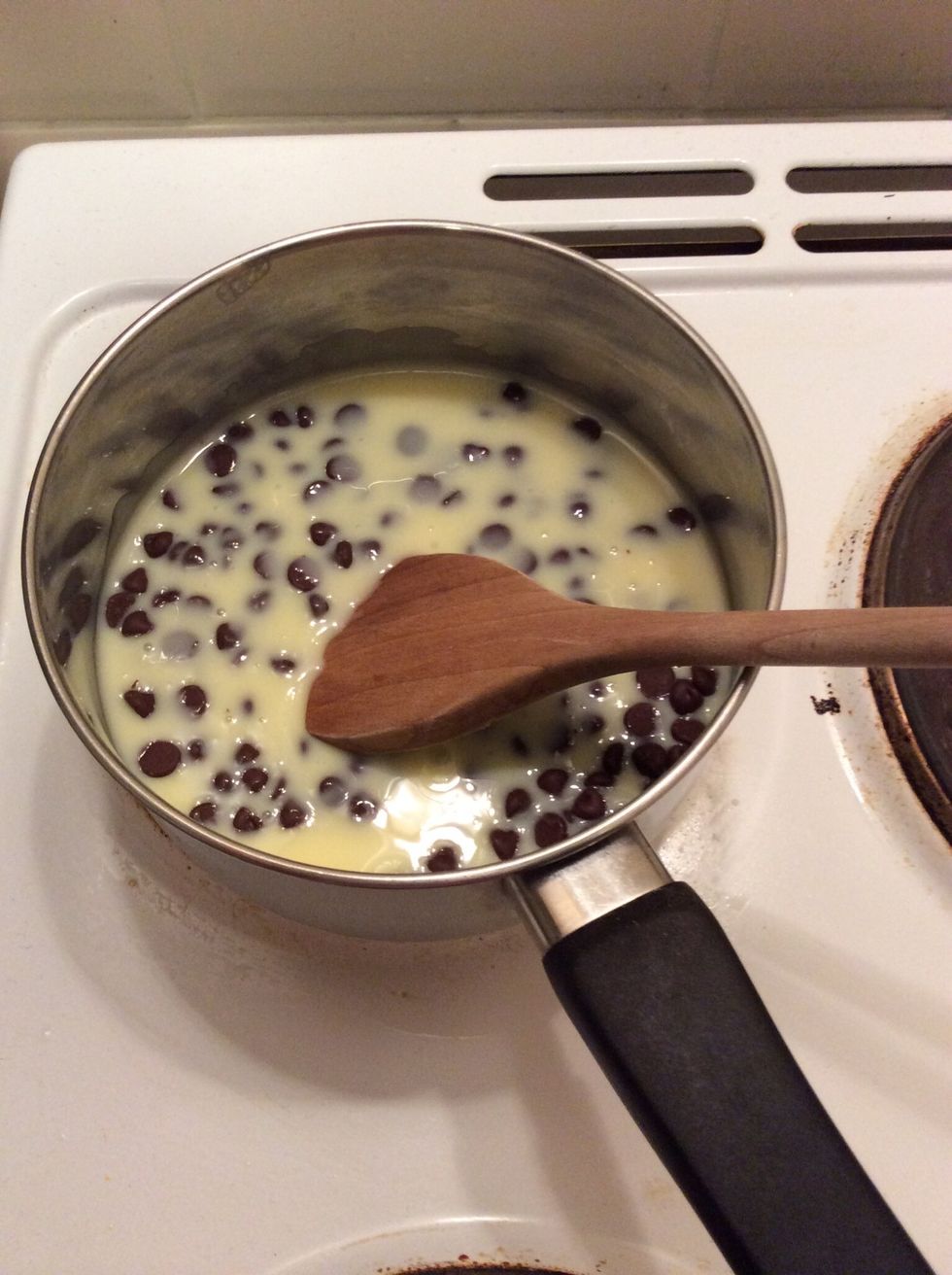 On a low heat carefully melt the choc chips into the condensed milk