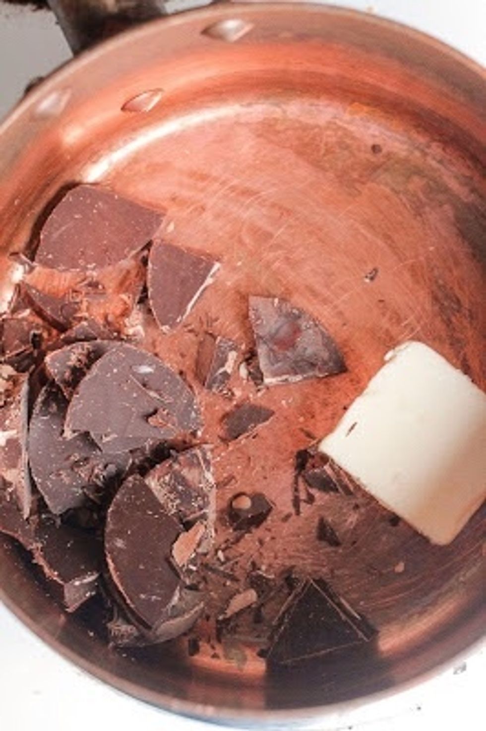 On a low heat, melt together the 2 oz of Mandarin Orange Chocolate with the 1 and 1/2 Tbs of unsalted butter.When they've melted, add in the milk, honey, and vanilla.Let it cool a couple of minutes.