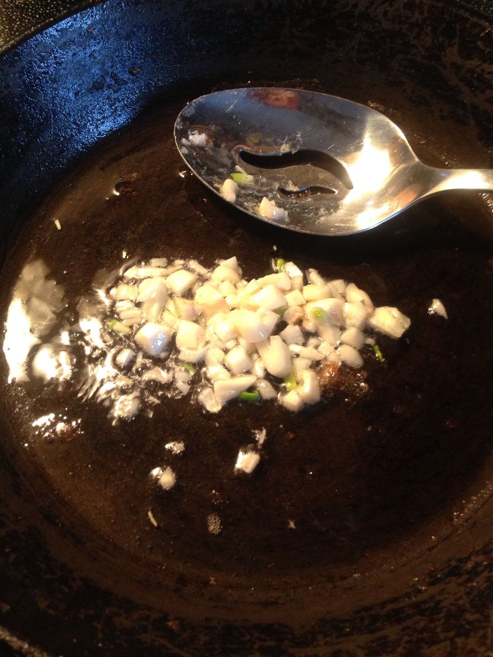 On a separate stove top, you need to cook your sauce. First, add 1 tablespoon of oil and your garlic