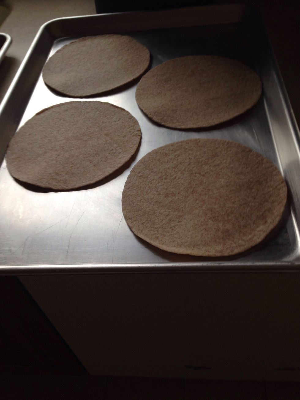 On a sheet tray lay the tortillas down. I am baking these, they are so easy this way, no oil needed and it only takes 15 minutes in the oven.