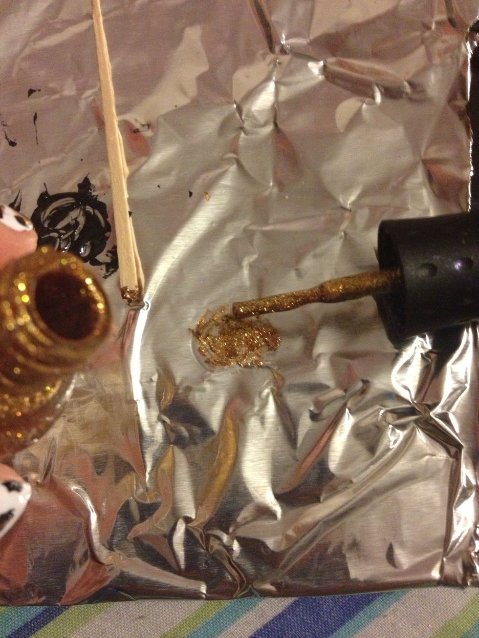 On a small piece of tin foil, paint a dot of gold nail polish.