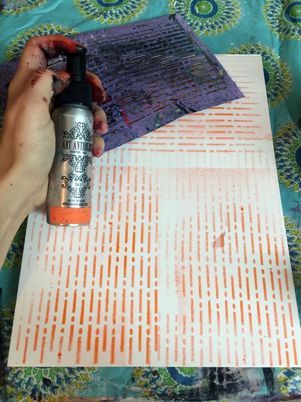 On an art journal page or watercolor paper spray Art Anthology's Juicy Colorations using Art Anthology's Morse Code stencil.