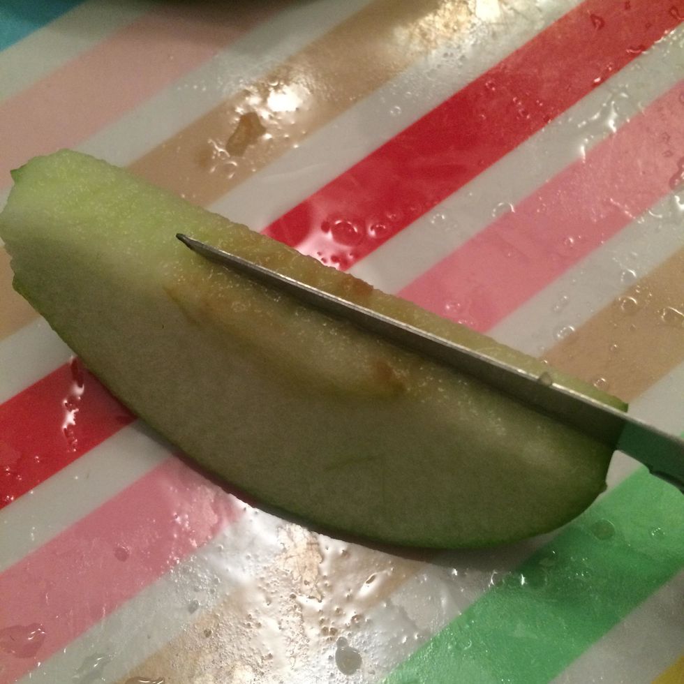 On another plate, take each apple slice and slice it in half again with a paring knife. It is okay if the apples get a little brown.