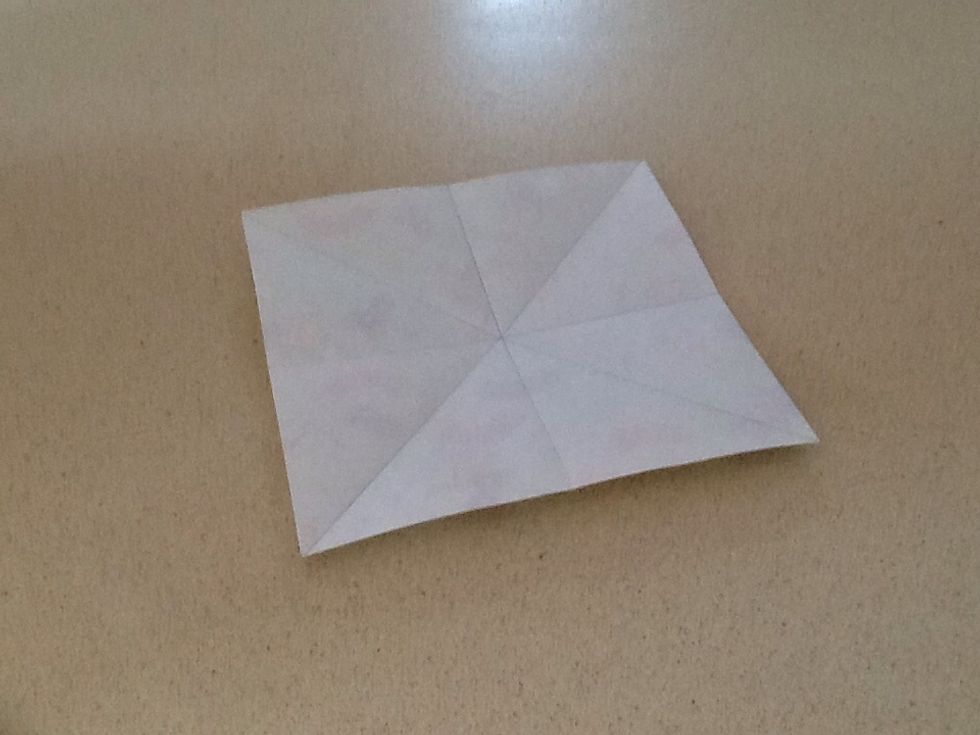 On both sheets of paper, fold in half vertically, horizontally and diagonally. I have outlined my creases in pencil so you can see them.