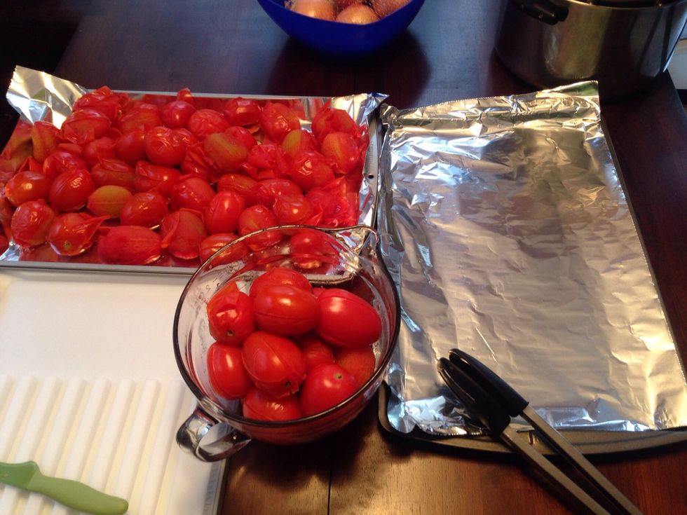 On clean sheet pans, spread out the cooked tomatoes to cool.