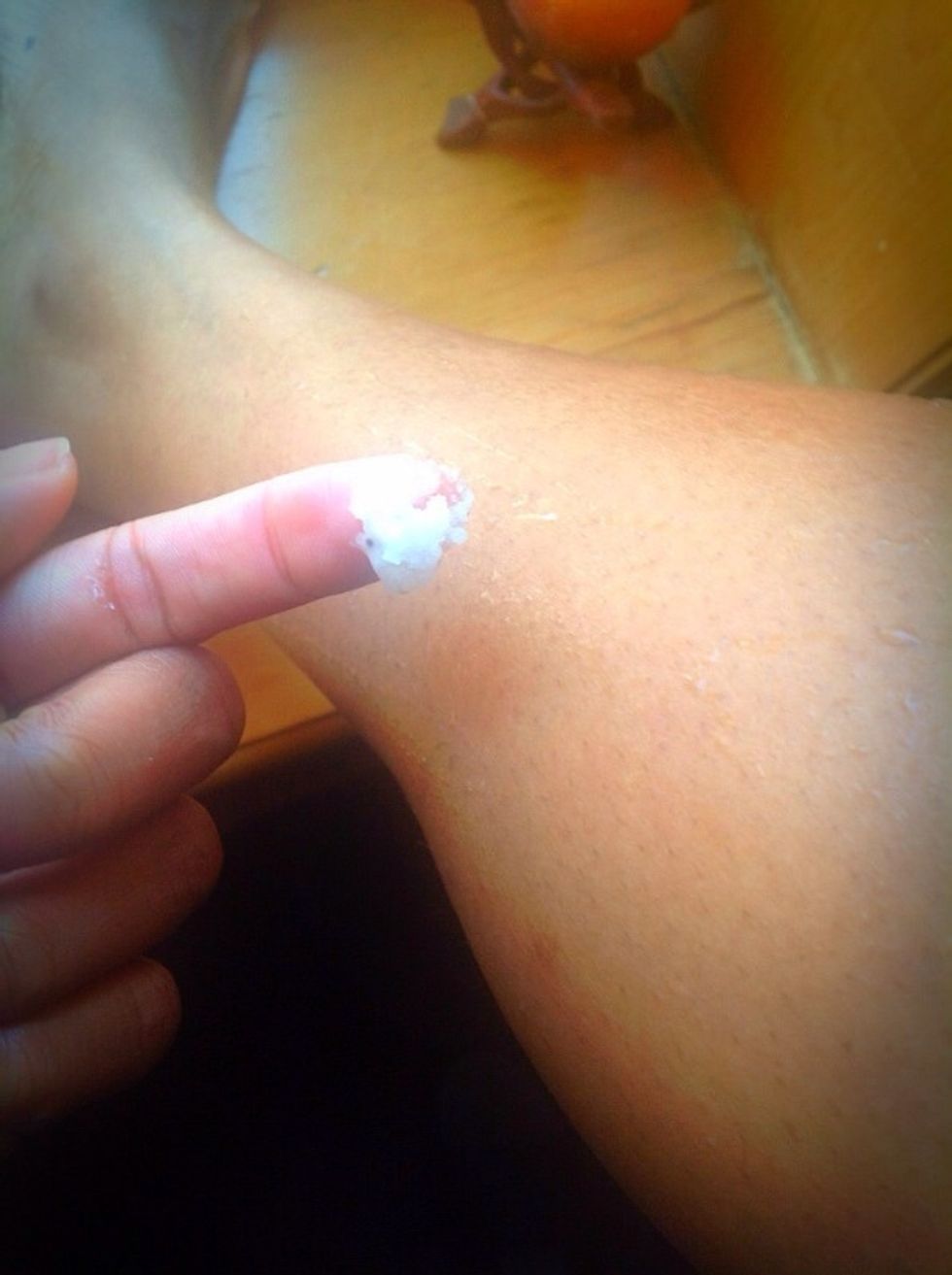On damp skin, take a small amount of your sugar/salt scrub and  apply starting from your ankles and calf