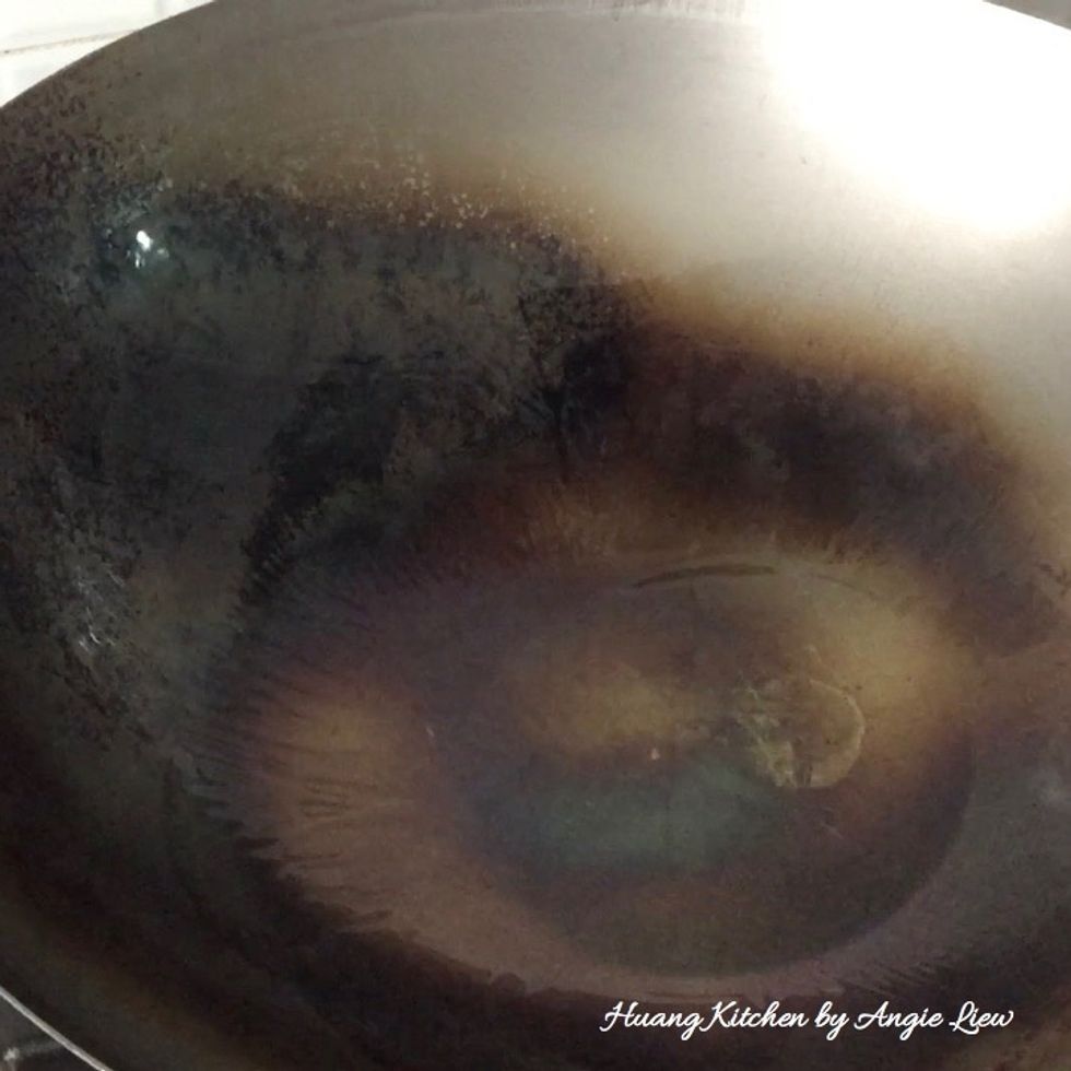 On high setting, heat up 2 tbsp oil in wok until very hot. Swirl in the oil to coat the bottom of wok. You will actually see smoke coming out of the wok.
