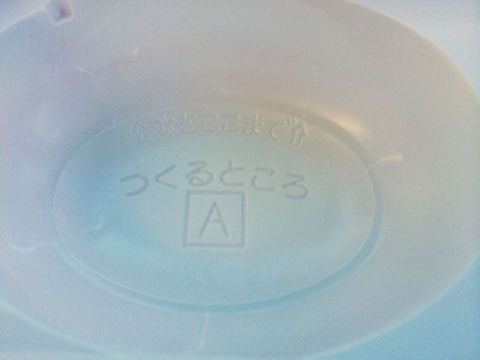 On Left Side of Tray with OVAL --Fill Water to Bottom most line-You will see the Pointing Arrow-It's not very much water, but do not add extra!!
