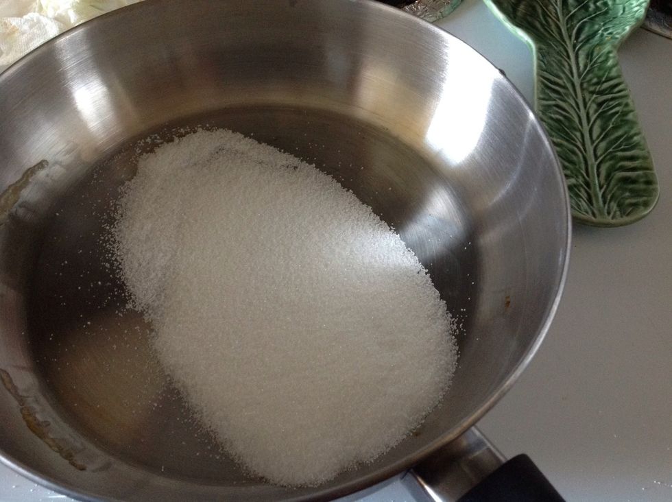 On medium/low heat add 1/4 cup sugar to a pan.