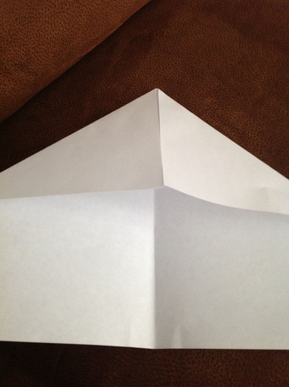 On one side of the paper, fold each corner in towards the center to the point where the inside edges are even with the centerline crease.
