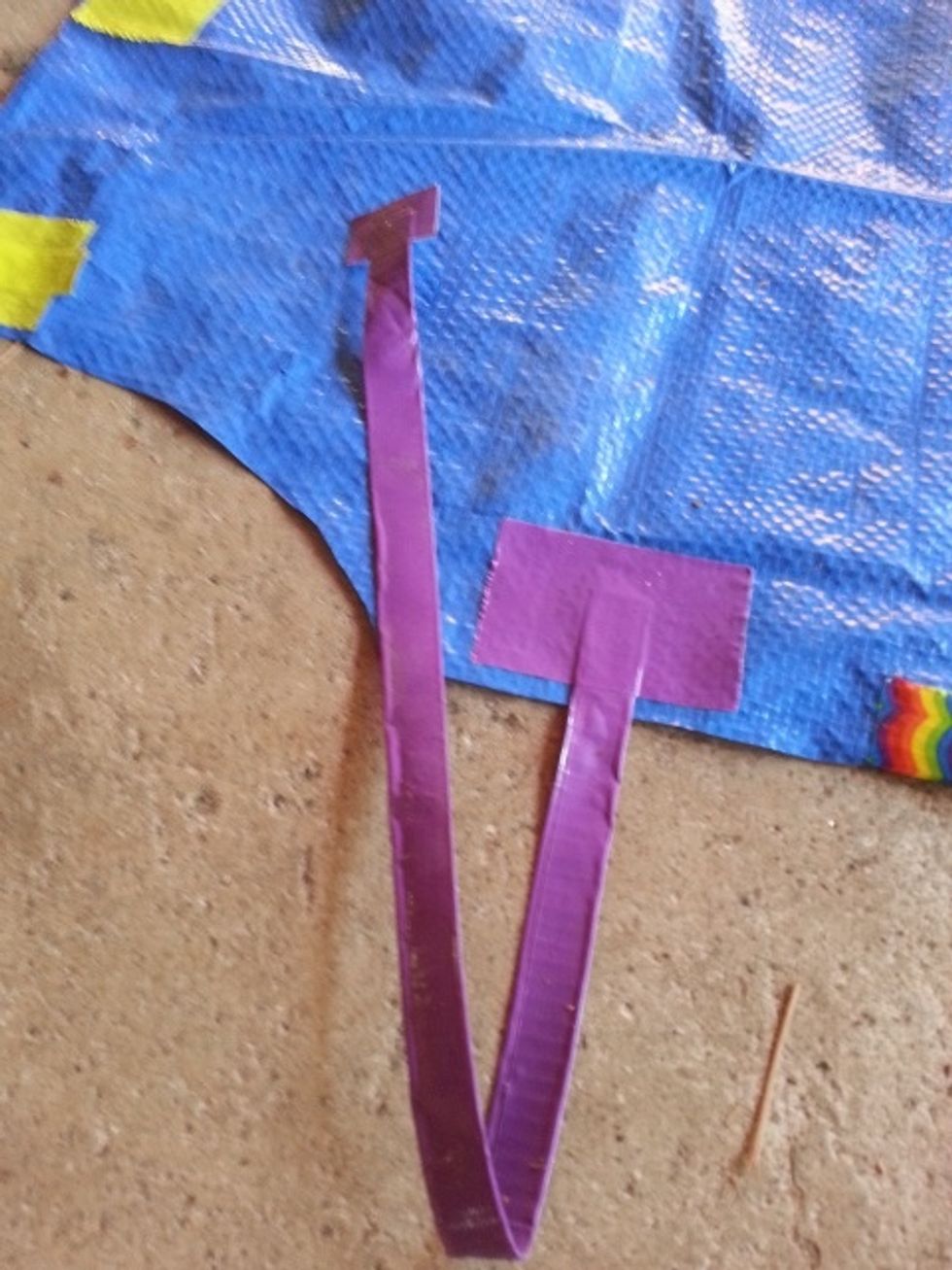 On other end of waist strap, make a "pull tab". Put a small piece of Velcro on the tab. Put apron on, pull waist strap around waist and put the other side of Velcro on the front of apron