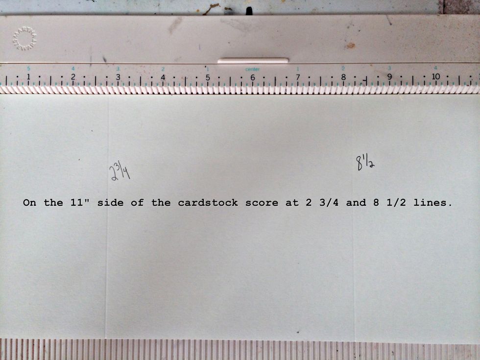 On the 11" side score at the 2 3/4 and 8 1/2 inch lines.