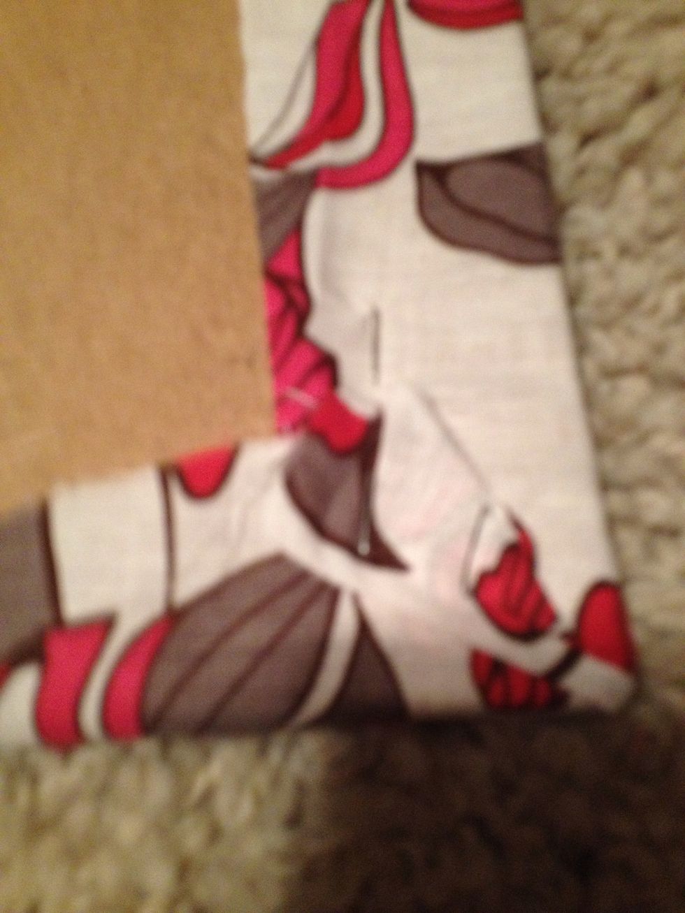 On the back bring fabric to a smooth and even corner. You may have to overlap a little. Staple the corners and edges so they remain tight