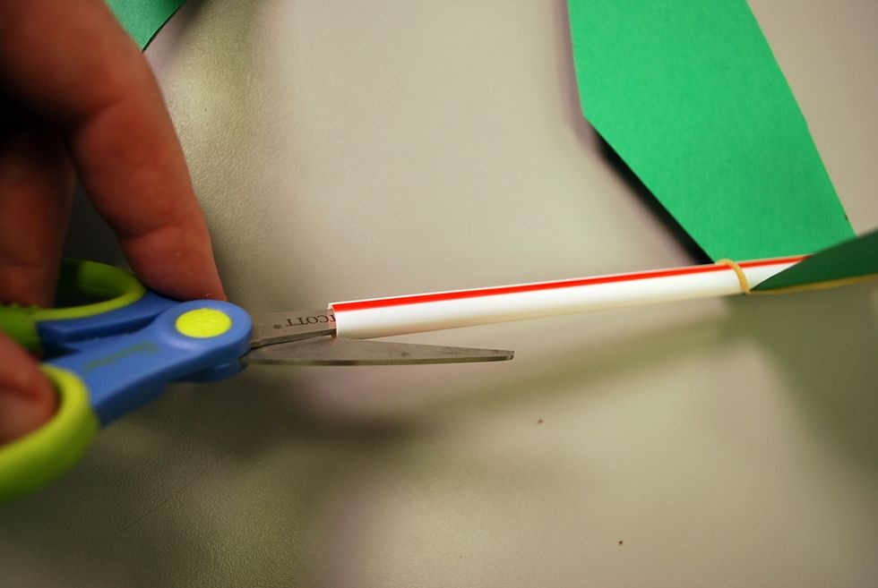 On the back end of the straw (based on what direction you put the wings) snip the end of the straw (about half an inch)