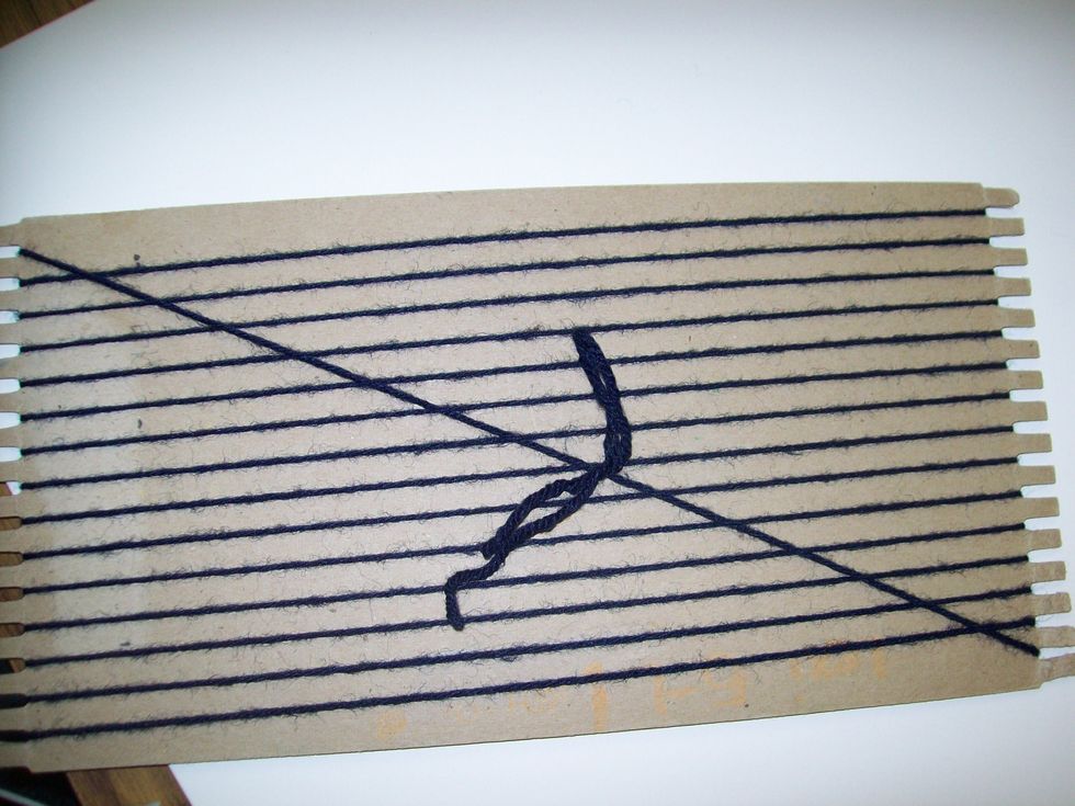 On the back of the loom, tie the ends of the yarn together making the warp of the loom tight. The warp is the vertical strings on the loom.