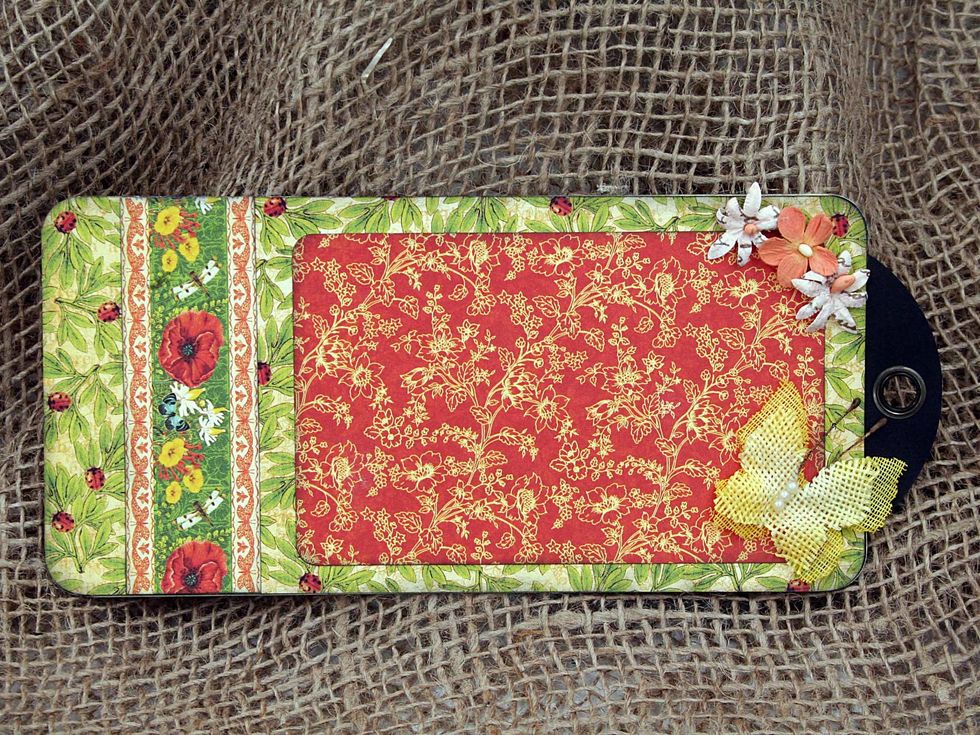 On the back of the same tag, add a decorative strip and a 5 1/8" x 3 1/4" photo mat, embellish with flowers and a butterfly.