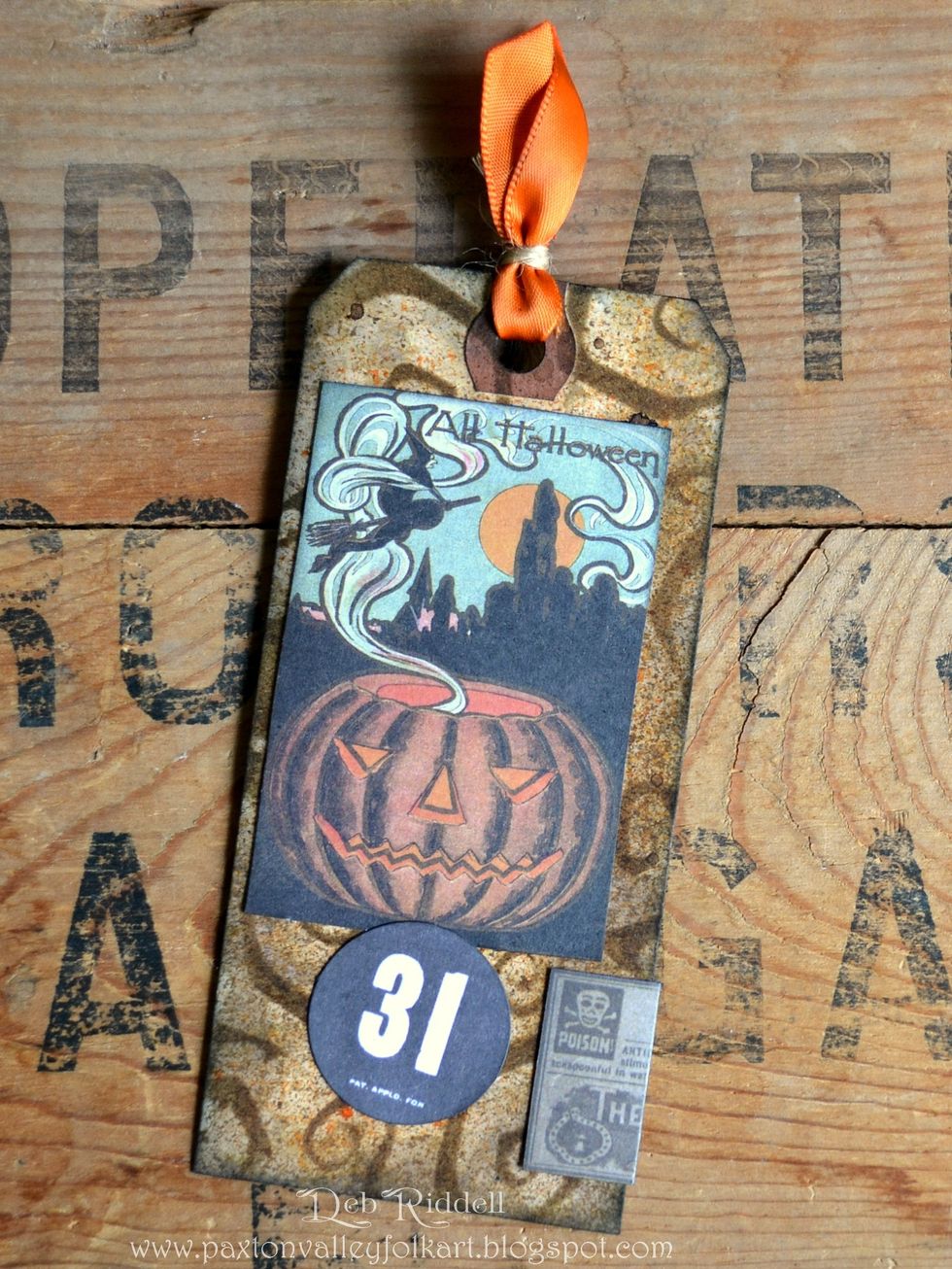 On the back of the same trimmed tag, select elements from the Frightful Ephemera pack and layer in place. You can see where I wrapped the chloroform ad to the back on this tag.