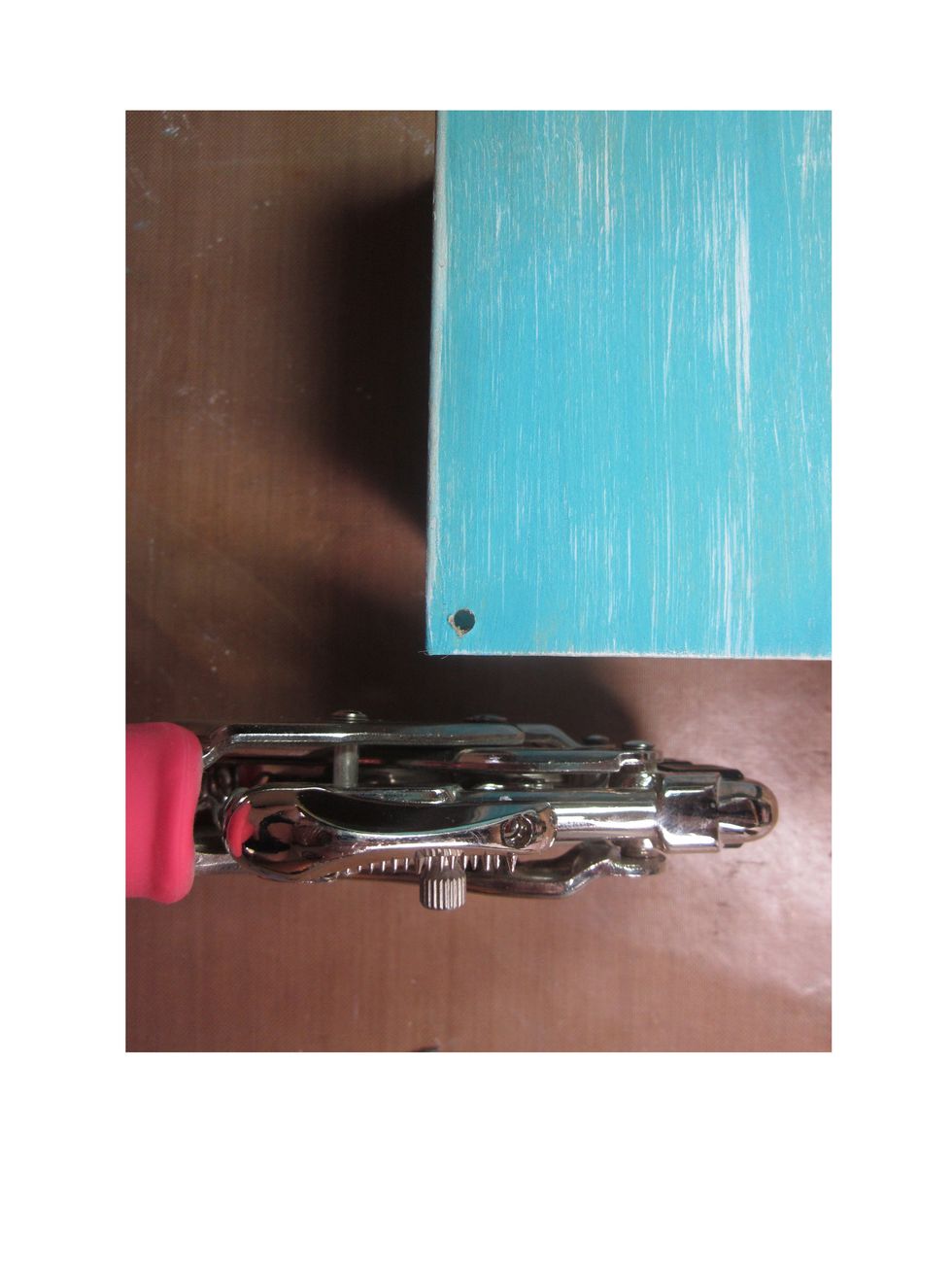 On the back outside corner of your box punch a small hole in your box that the wheel will go through.  Do on both sides of the back of the box for each wheel.