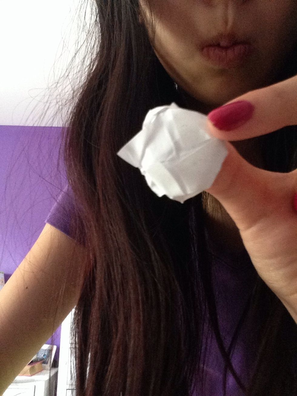 On the back there should be triangles. Fold then out for them to peel out under the flower.