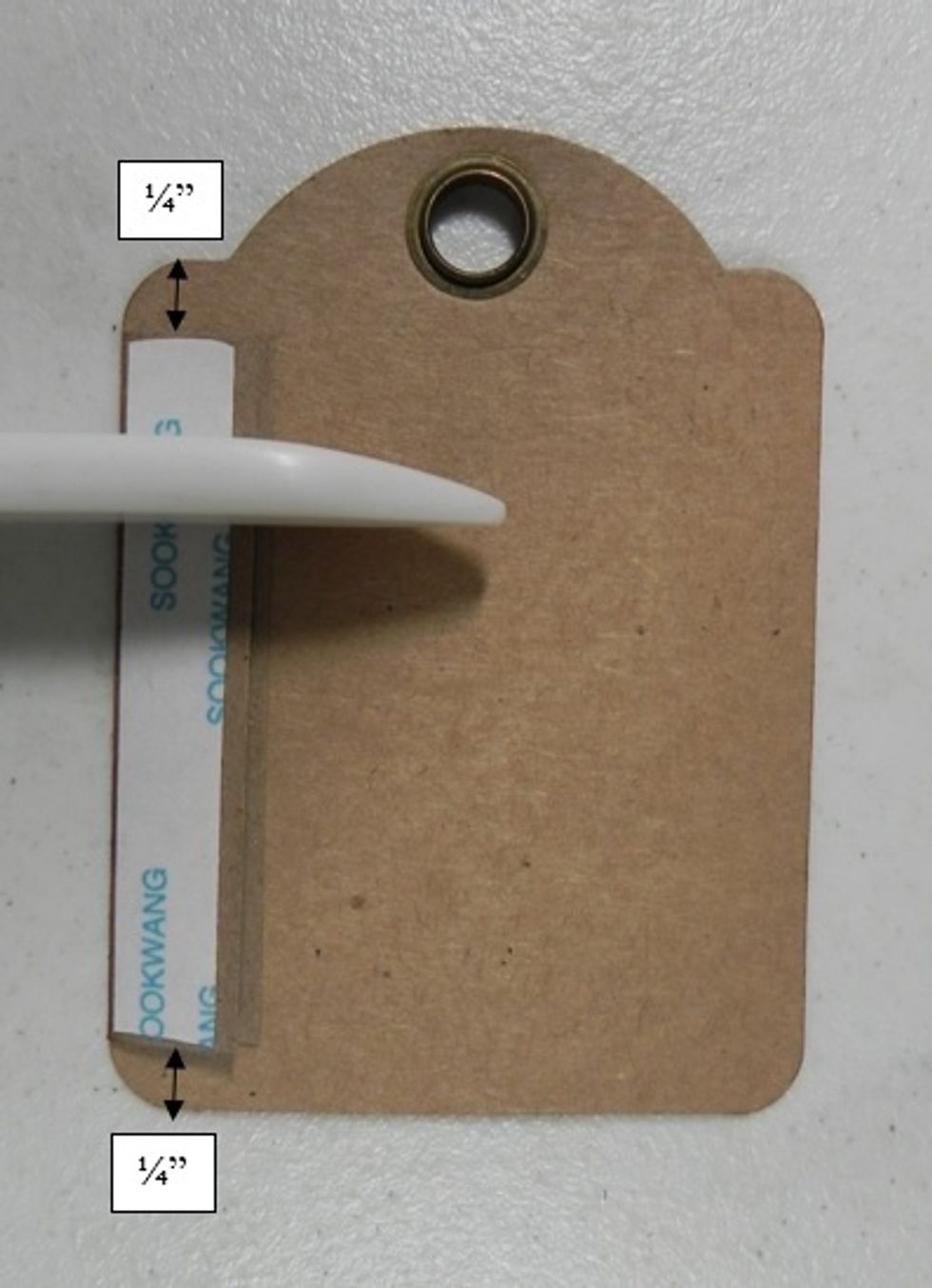On the backside of the tag, attach a hinge piece flush to the edge, 1/4" from the top and bottom.